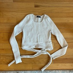 white long sleeve cropped shirt with a cute tie in the back